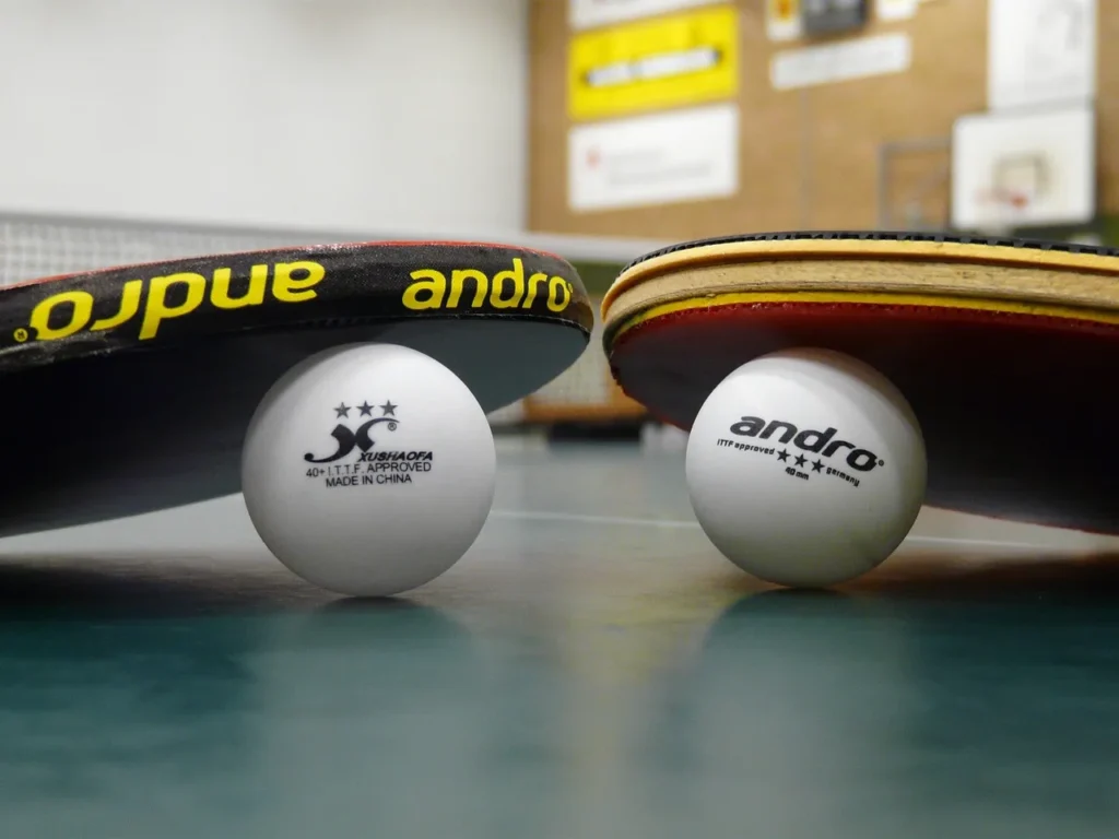 The image shows two Table tennis rackets with two Table tennis Balls Table Tennis Blade